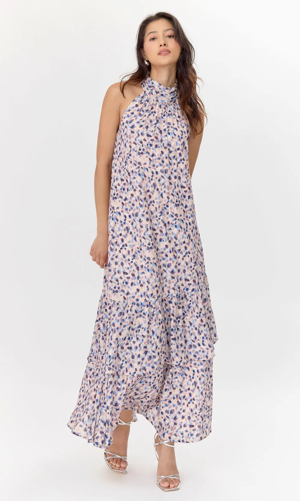 Front view of model wearing pink, polka-dotted midi dress with a halter neckline.